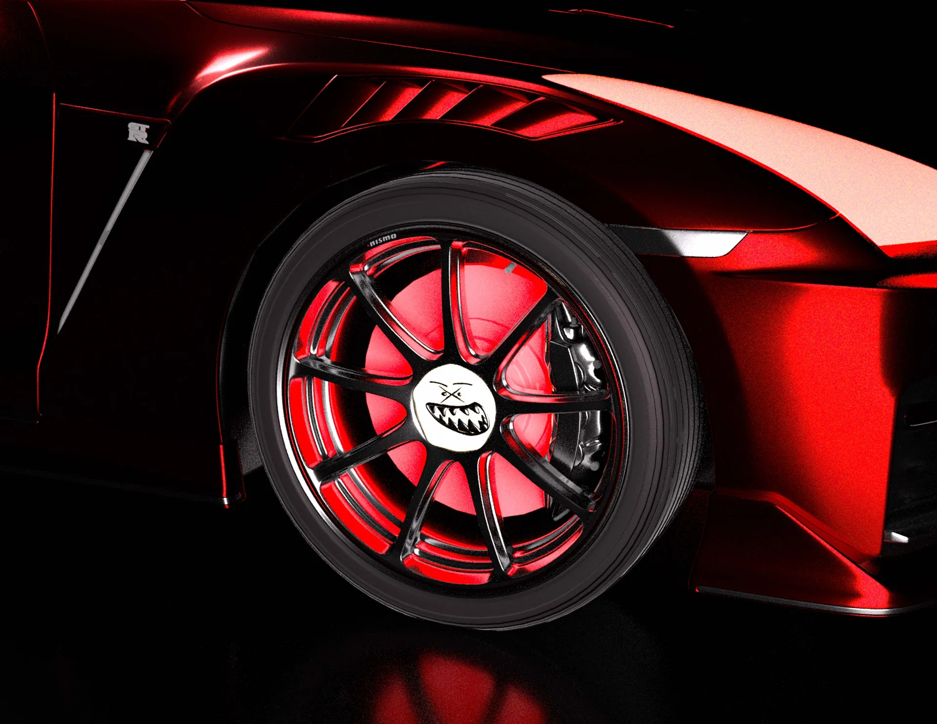 Ghost automotive branding applied to the wheel of a red and black sports car