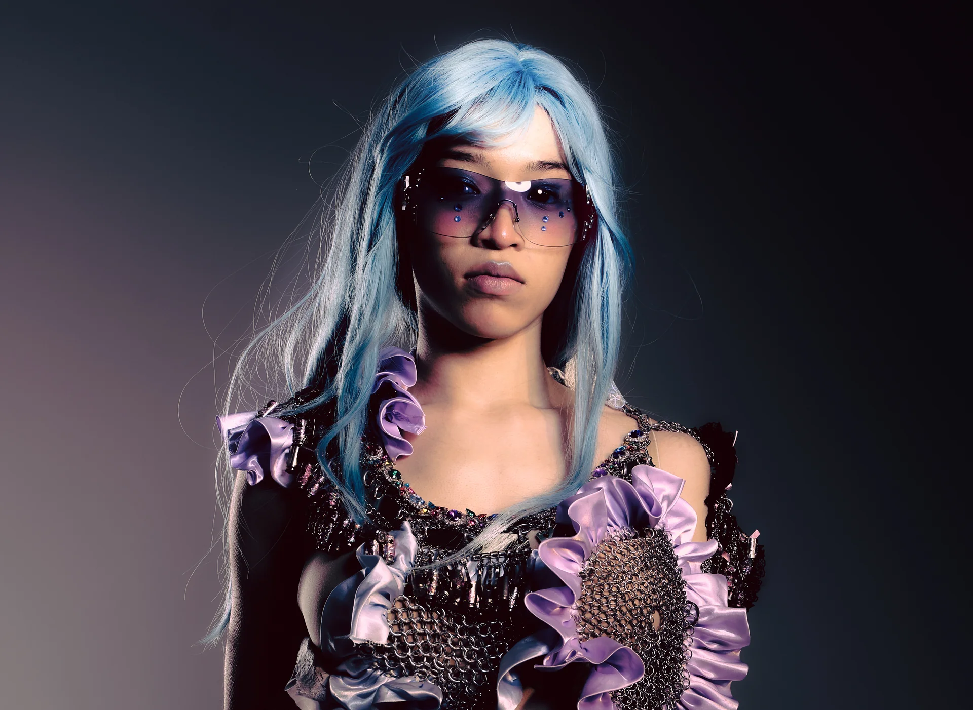 Blue-haired model wearing chainmail and lilac ruffles from Party at the End of the World
